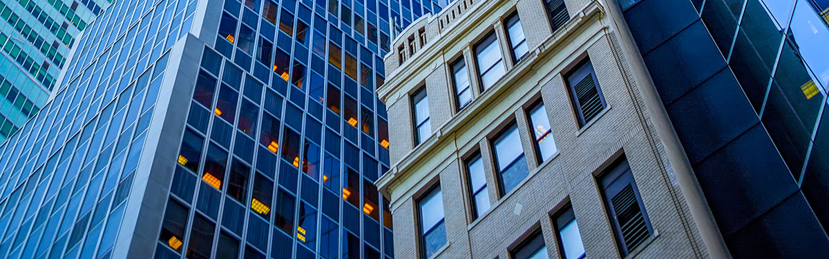 An upward-angled view of city buildings