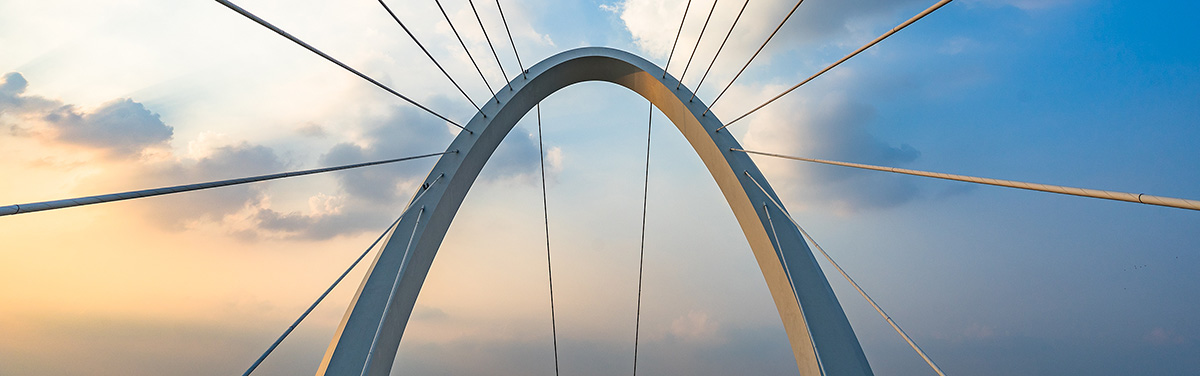 Close-up view of a modern arch bridge with suspension cables