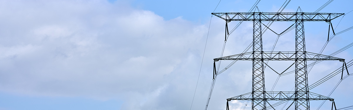 electrical tower against a cloudy blue sky