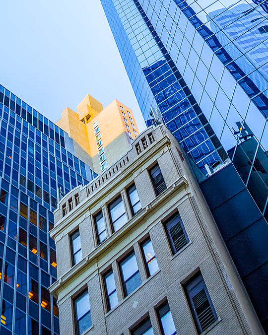 An upward-angled view of city buildings