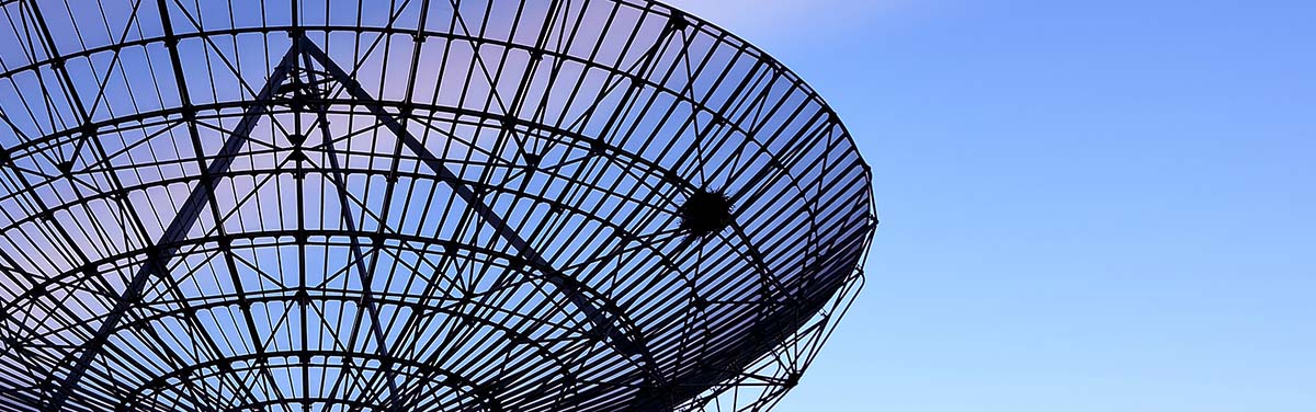 large satellite dish against a blue sky